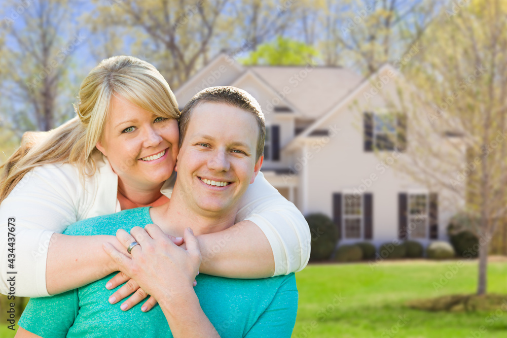 Happy Caucasian Couple in Front of New House