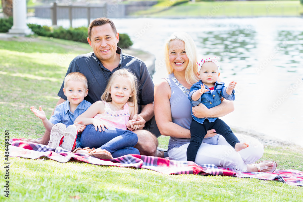 Fototapeta premium Happy Young Caucasian Family Portrait In The Park