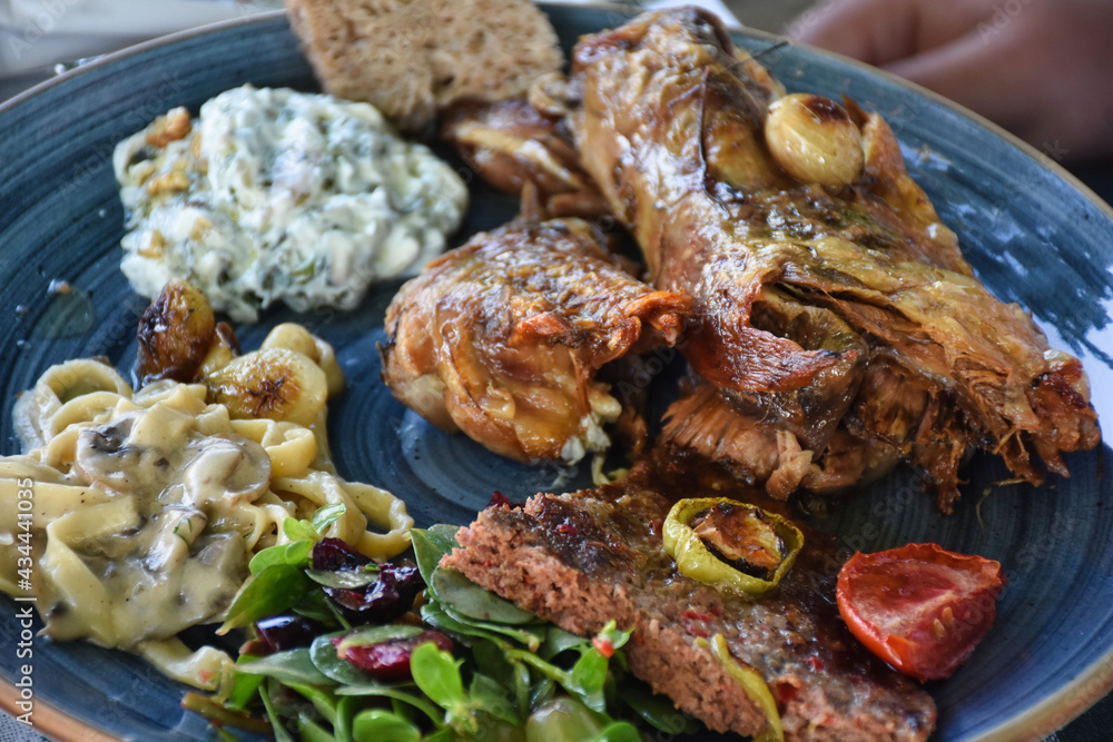 Goat meat cooked in tandoor, pasta and various appetizers. Traditional Aegean Islands food. Goat meat cooked in tandoor, pasta and various appetizers. Traditional Aegean Islands food.