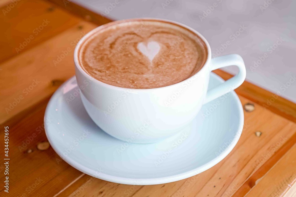 a coffee latte in a white cup with latte art a coffee latte in a white cup with latte art