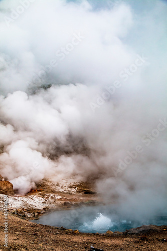 steaming hot spring during a wintry autumn in Yellowstone National Park in Wyoming.