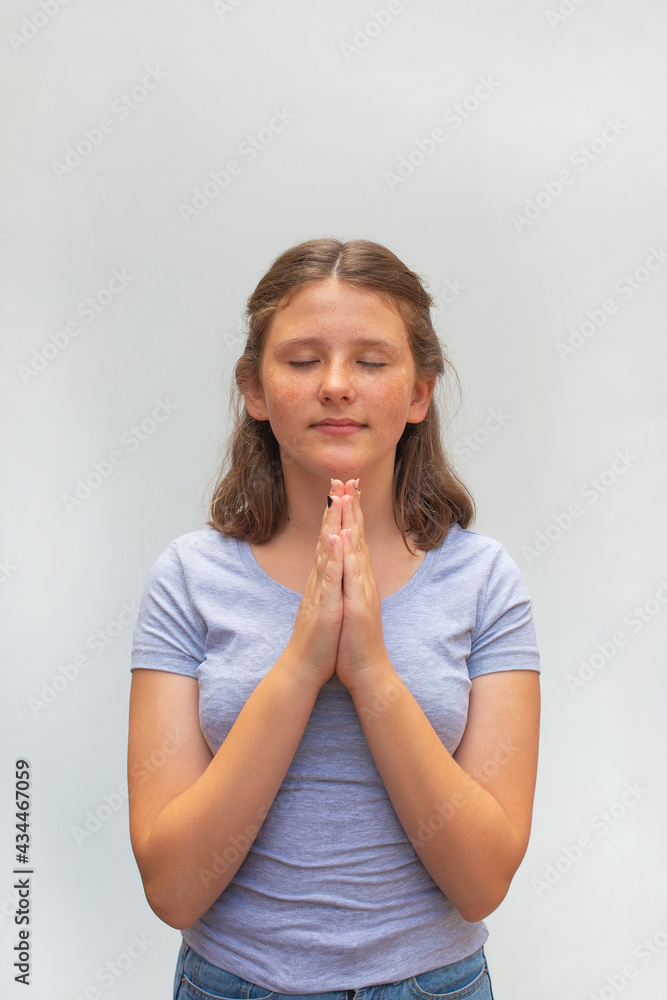 caucasian teenager girl keeps hands in praying gesture caucasian teenager girl keeps hands in praying gesture