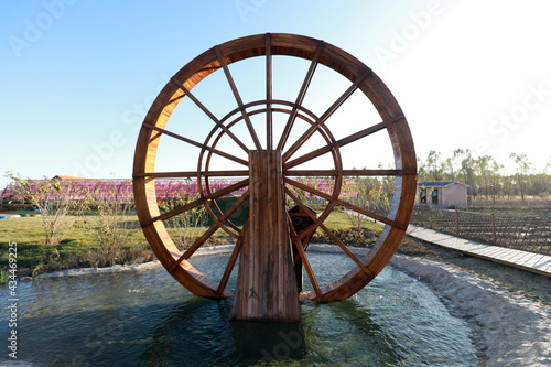 Wooden waterwheel architecture landscape in the park photo