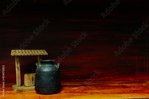 House decoration, water well and ceramic vessel. Little and rustic decoration on wooden furniture.