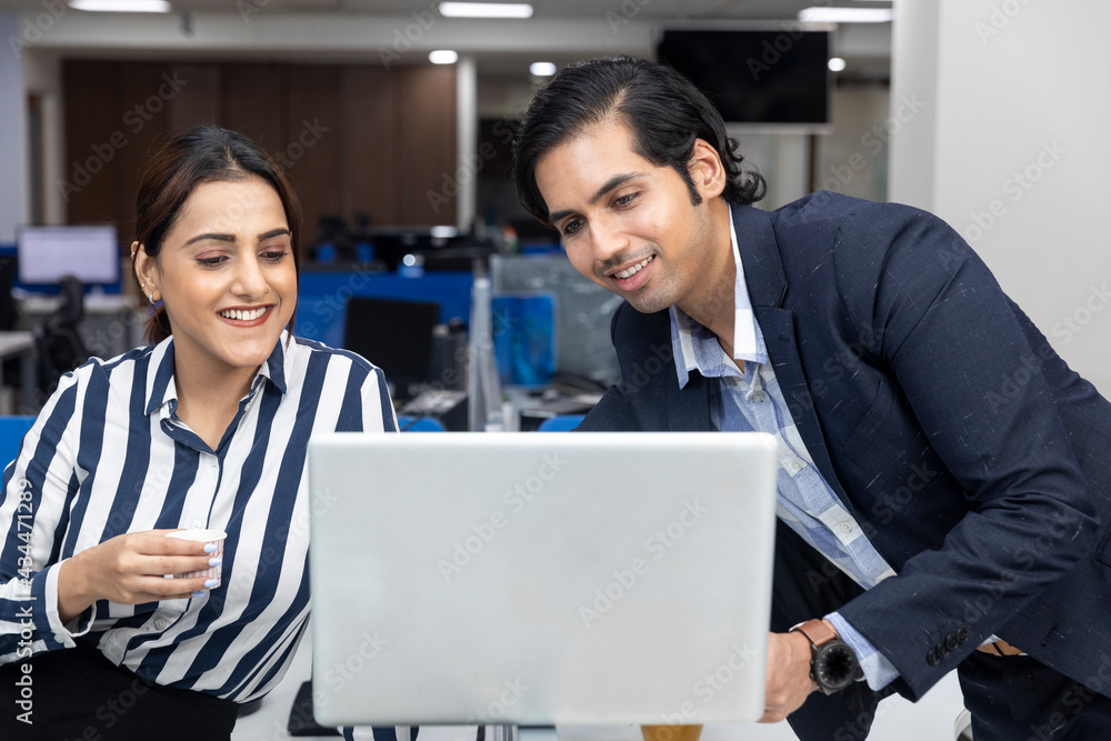 Portrait of two young Indian businesspeople having video conference with colleague, project discussion, corporate environment. Portrait of two young Indian businesspeople having video conference with colleague, project discussion, corporate environment.