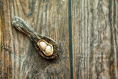 Peanuts on wooden spoon.