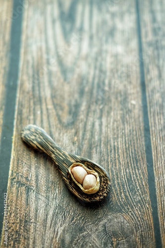 Peanuts on wooden spoon.