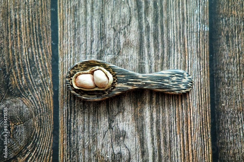 Peanuts on wooden spoon.
