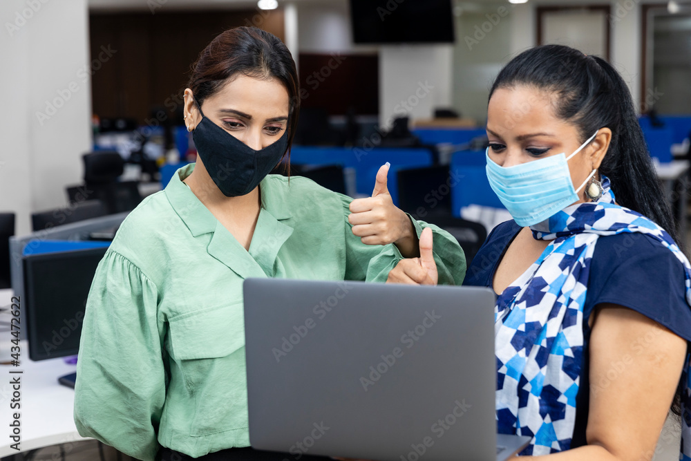An Indian office employee pins a paper onto the noticeboard requesting colleagues not to sit in a group so as to maintain social distancing. An Indian office employee pins a paper onto the noticeboard requesting colleagues not to sit in a group so as to maintain social distancing.