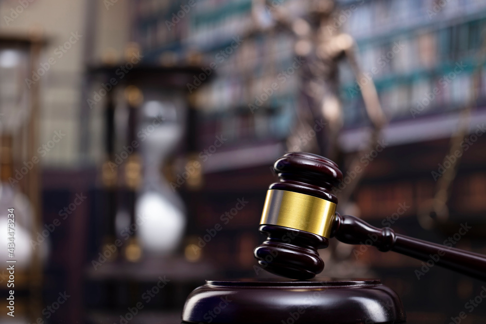 Law and justice concept. Gavel of the jugde, Themis sculpture and scale of justice in the court library. Law and justice concept. Gavel of the jugde, Themis sculpture and scale of justice in the court library.