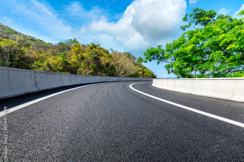 Mountain road landscape under blue sky.