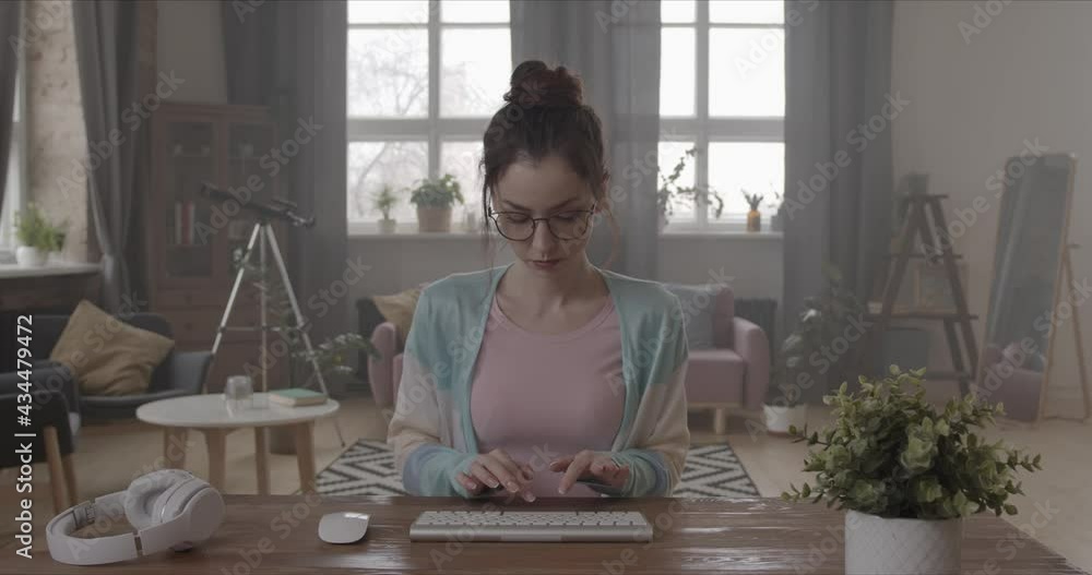 Young woman typing on the keyboard at the computer Young woman typing on the keyboard at the computer