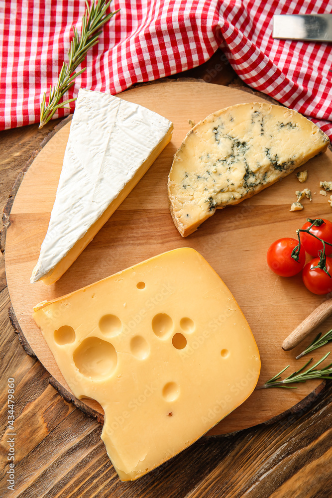 Composition with different types of cheese on wooden background