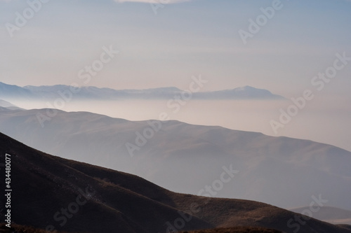 Mountain landscape with smoke on background. Almaty air pollution concept. Ushkonyr plateau, Kazakhstan. © Adil