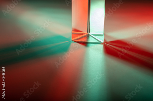 Colorful light play with a prism, made with colored strobe light on white sheet of paper. painting with green and red light.