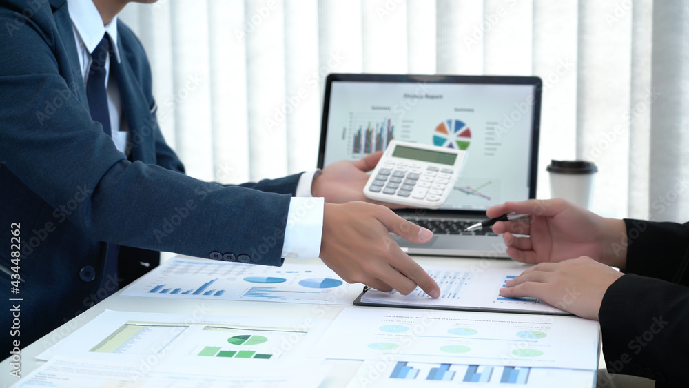 Business concept a couple of business partners calculating annual income and expense for creating the next financial plan. Business concept a couple of business partners calculating annual income and expense for creating the next financial plan.