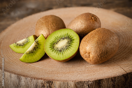 Fresh kiwi fruits on wood, close-up photo