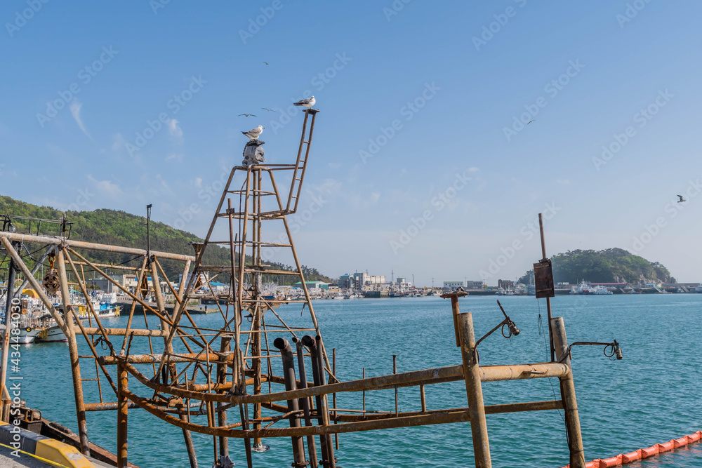 Seagulls perched on mast of remains of trawler damaged by fire. Seagulls perched on mast of remains of trawler damaged by fire.