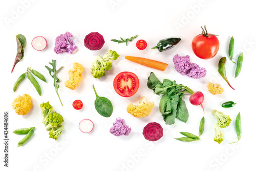 Fresh vegetables overhead flat lay composition on a white background. A variety of healthy vegan salad ingredients