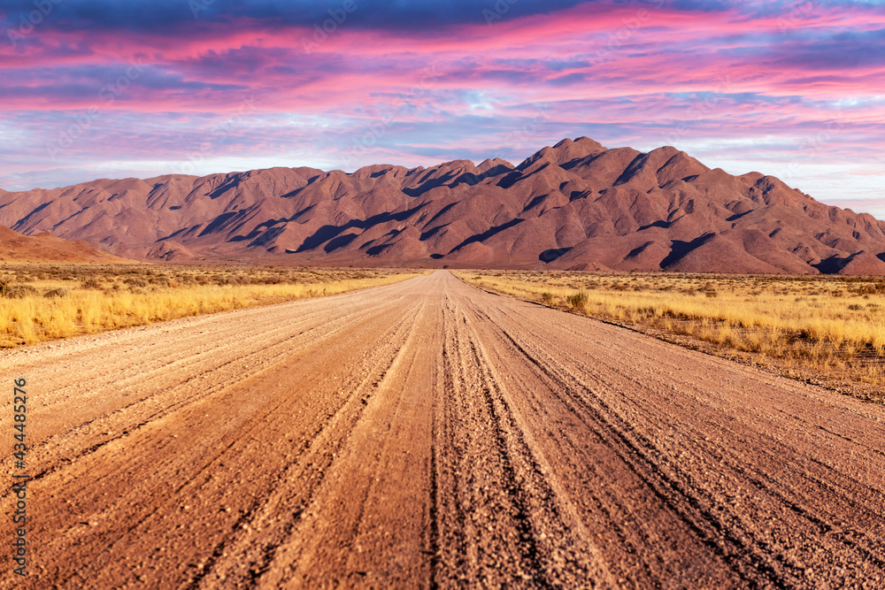 Gravel road and beautiful landscape with sunset sky