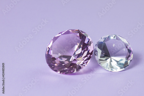 Purple precious gemstones for design gems jewellery. Diamonds crystal on turquoise background.