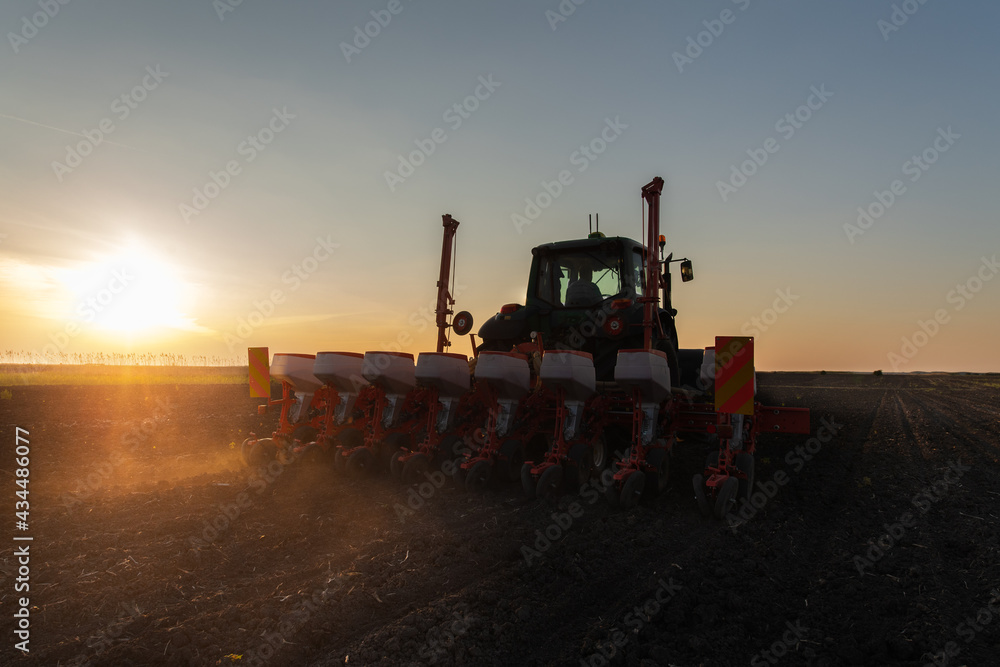 Farmer with tractor seeding Farmer with tractor seeding