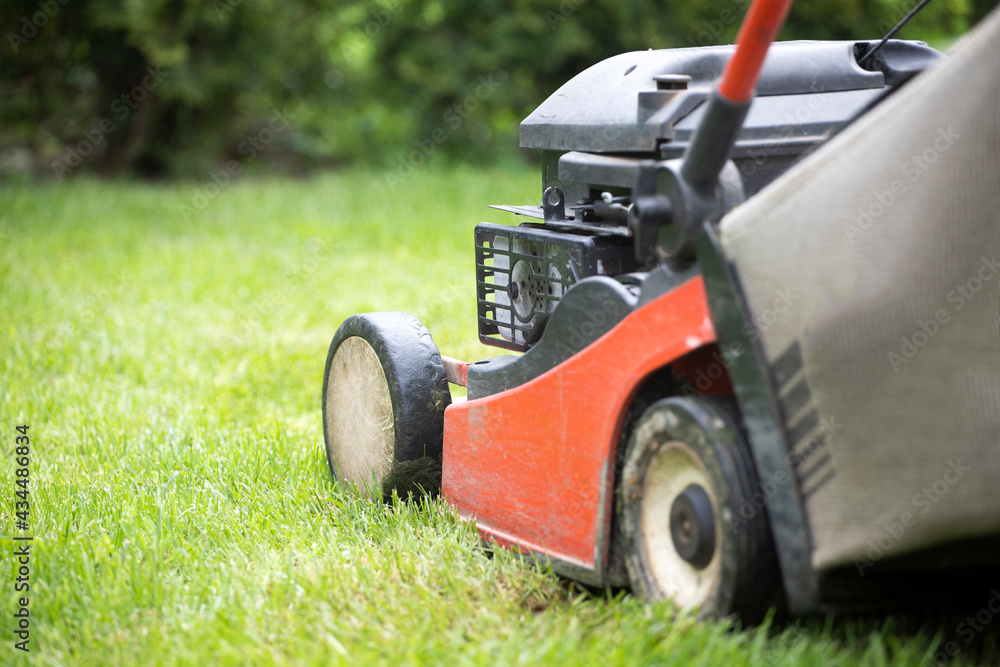 Lawn mover on green grass. Machine for cutting lawns. Lawn mover on green grass. Machine for cutting lawns.