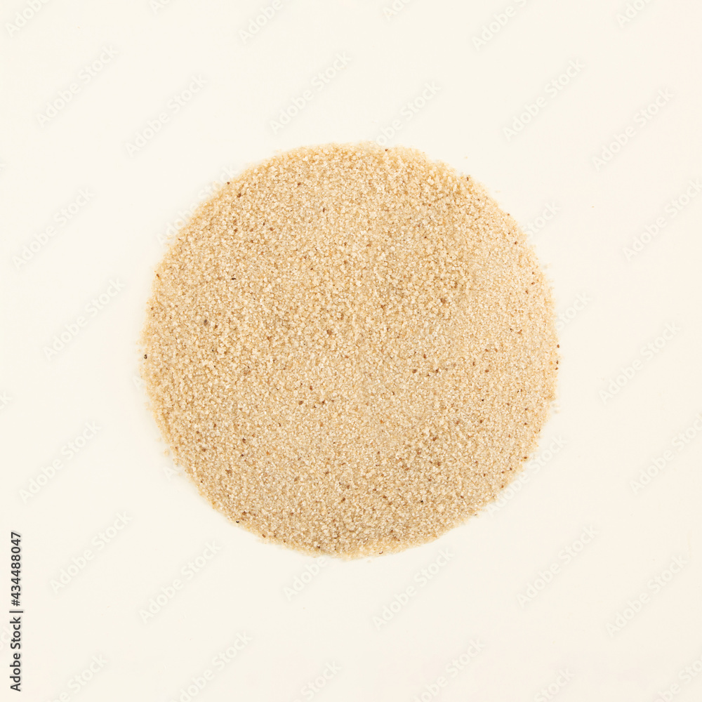 Sandy texture circle made of African ancient cereal fonio millet gluten free whole grain on a pastel beige background. Minimal organic natural healthy food flat lay concept with copy space. Sandy texture circle made of African ancient cereal fonio millet gluten free whole grain on a pastel beige background. Minimal organic natural healthy food flat lay concept with copy space.