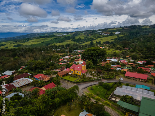 Beautiful aerial view of the Aquiares town and its iconic yellow church in Cartago Costa Rica photo