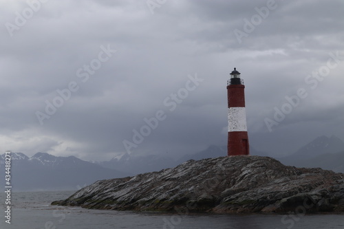 Lighthouse on the end of the world, famous sign in the beagle channel, red and white house to orientate on the ocean, landmark near by the coastline in tierra de fuego patagonia argentina © Sarah Zezulka