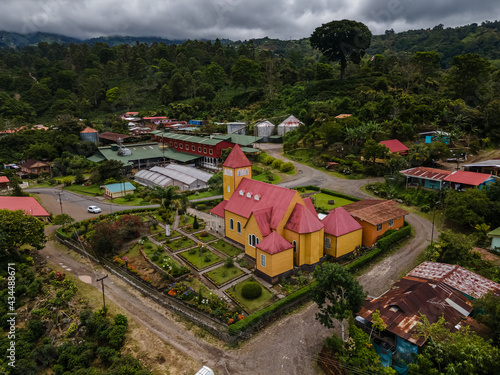 Beautiful aerial view of the Aquiares town and its iconic yellow church in Cartago Costa Rica photo