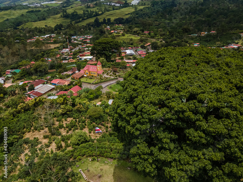Beautiful aerial view of the Aquiares town and its iconic yellow church in Cartago Costa Rica