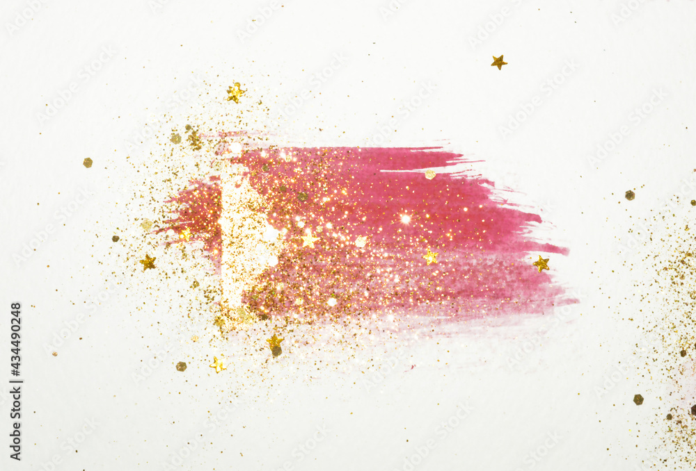 Golden glitter and glittering stars on abstract pink and gold watercolor splash in vintage nostalgic colors