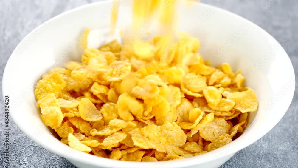 cornflakes pouring into a bowl cornflakes pouring into a bowl