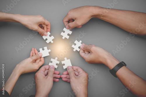 Team work, hands and jig Saw Unite with power Is a good team of successful people Team work concept