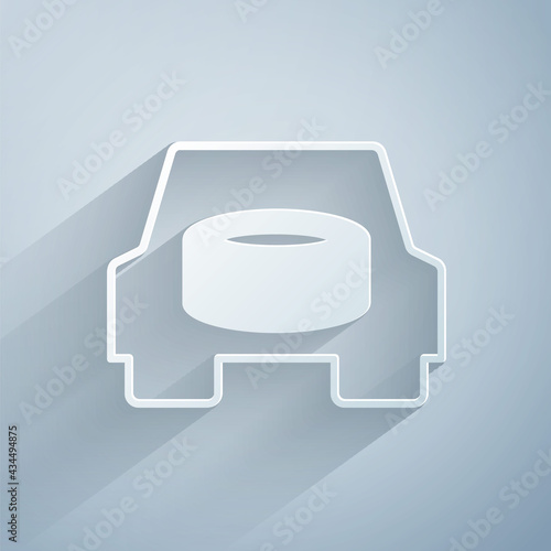 Paper cut Spare wheel in the car icon isolated on grey background. Process of replacing the wheel. Storage location of the spare wheel in the trunk. Paper art style. Vector