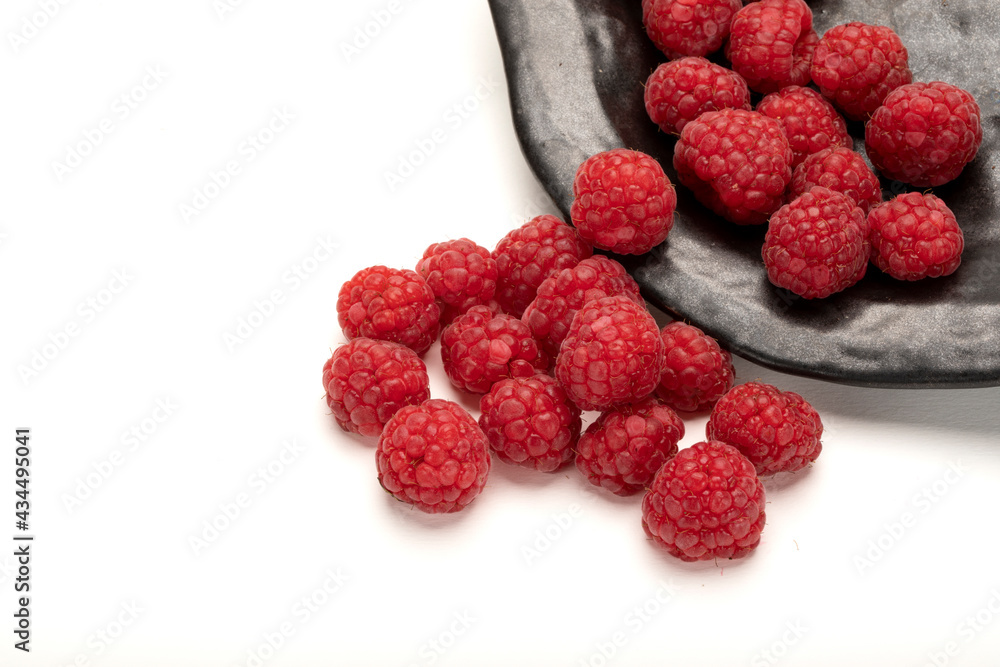 Fresh raspberries on a black plate. Fresh raspberries on a black plate.