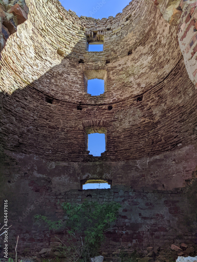 old and ruined brick windmill inside view