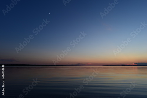 Twilight blue sky with a glow young moon
