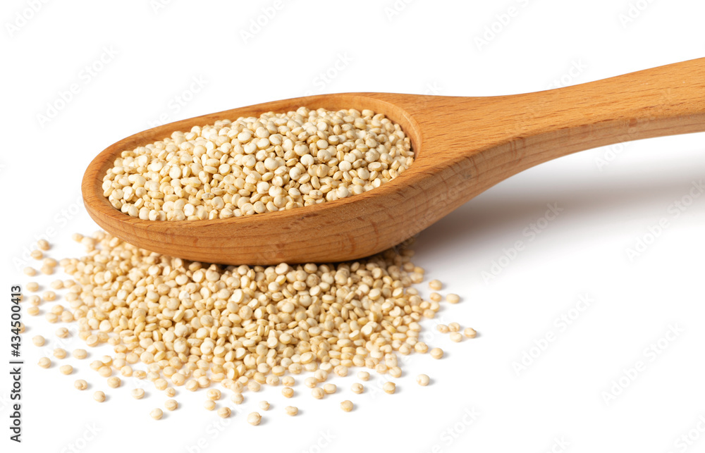 uncooked white quinoa in the wooden spoon, isolated on white background uncooked white quinoa in the wooden spoon, isolated on white background