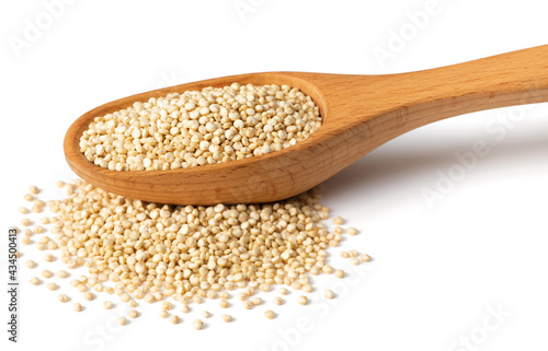 uncooked white quinoa in the wooden spoon, isolated on white background