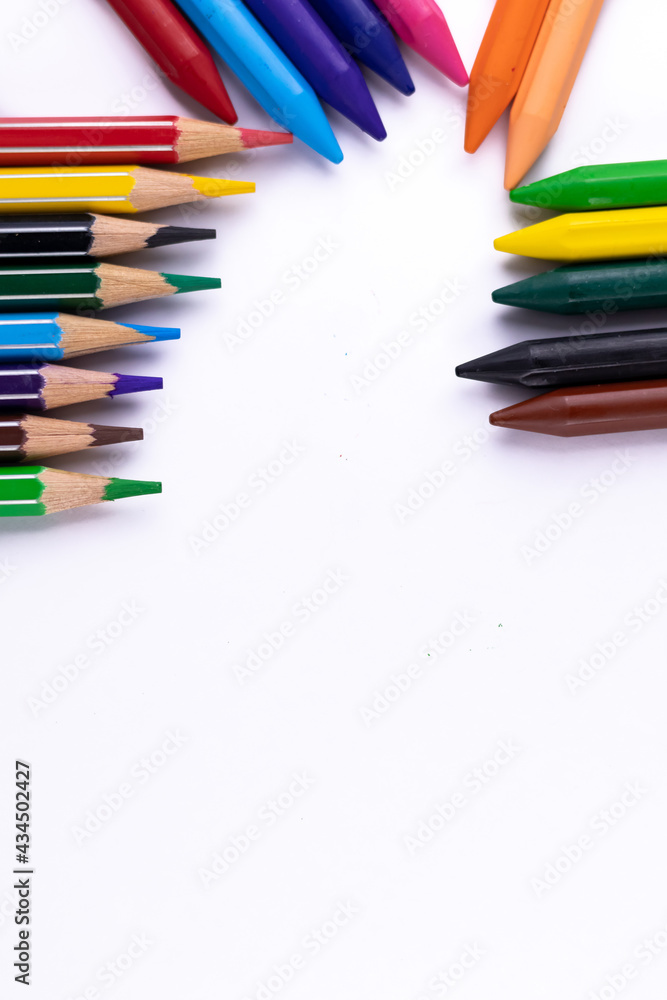 Fototapeta premium Scattered crayons and pencil colors on white background -Art and Education concept.