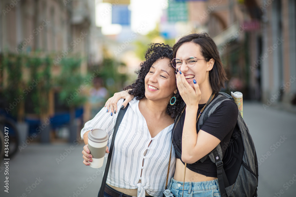 Two happy tourist women on street.