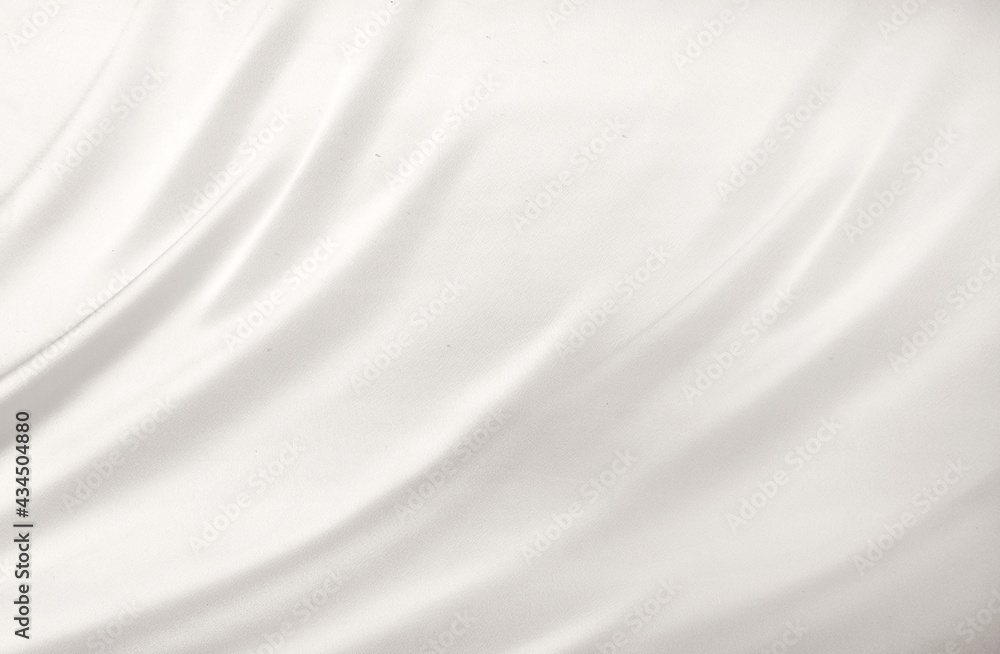 Smooth elegant white silk or satin luxury cloth texture can use as wedding background. Luxurious background design. White silver fabric silk background with beautiful soft blur pattern natural.