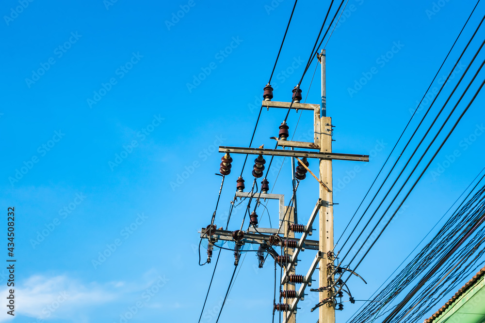 The electric pole, The electric post show with high voltage construction and voltage transmission line, beautiful blue sky background The electric pole, The electric post show with high voltage construction and voltage transmission line, beautiful blue sky background