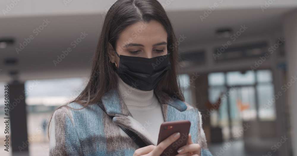 Woman with face mask using a smartphone Woman with face mask using a smartphone