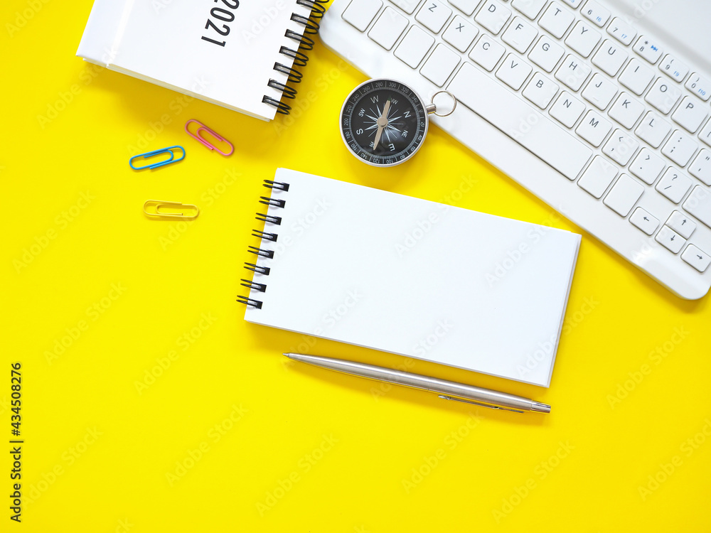 Top view, Flat lay, blank notepad on office yellow workplace tabletop with pen, keyboard, calendar, compass. Copy space for your text. Business and education concept. . Top view, Flat lay, blank notepad on office yellow workplace tabletop with pen, keyboard, calendar, compass. Copy space for your text. Business and education concept. .