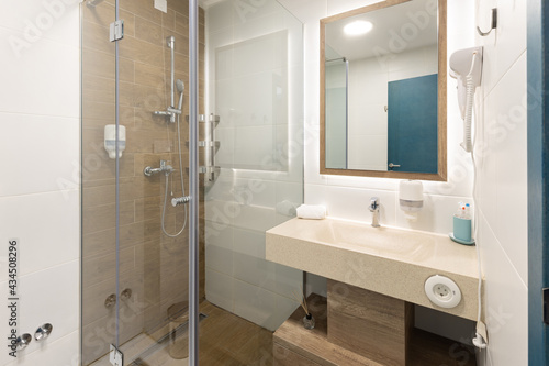 Interior of a luxury hotel bathroom with glass shower cabin