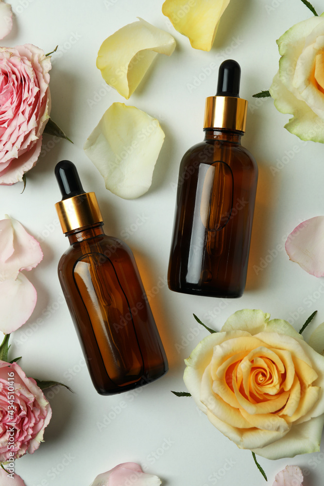 Skin care concept with essential rose oil on white background Skin care concept with essential rose oil on white background