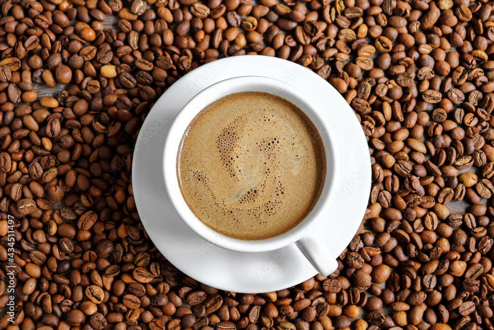 Horizontal banner with a cup of coffee and coffee beans. Top view. Copy space. Espresso or Americano in a cup. Coffee beans background Horizontal banner with a cup of coffee and coffee beans. Top view. Copy space. Espresso or Americano in a cup. Coffee beans background